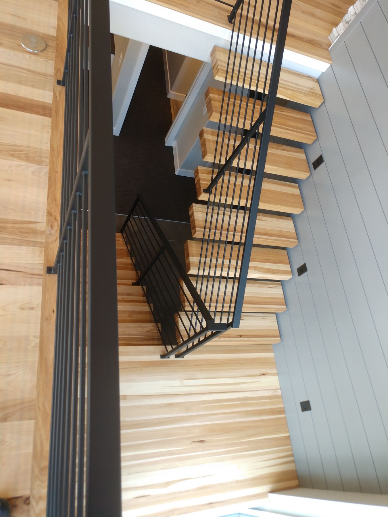 Floating open-riser stair with wood treads