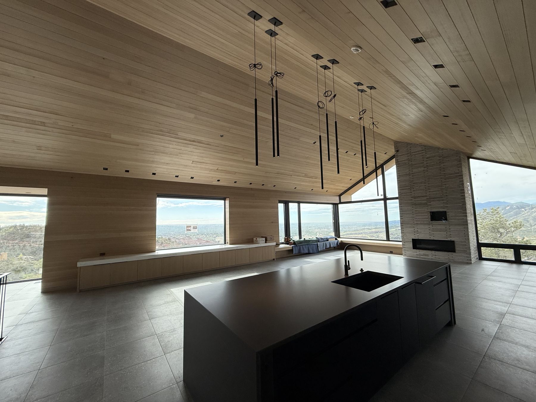 Kitchen island under a tongue-and-groove wood ceiling